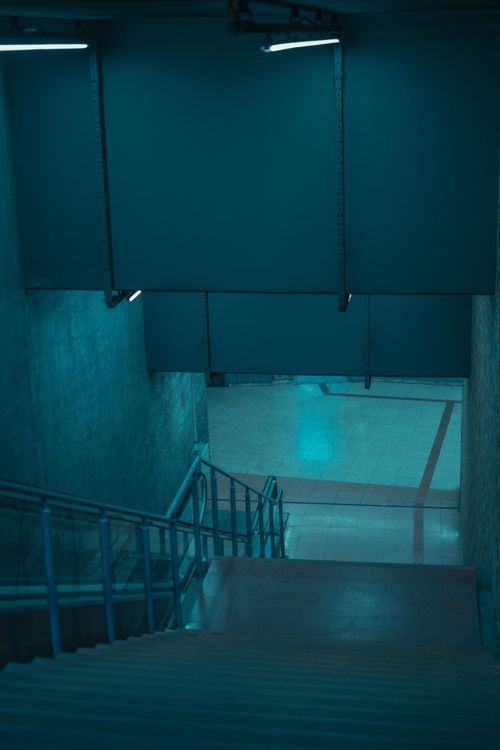 Free Explore a contemporary blue lit underground staircase in an urban setting. Stock Photo