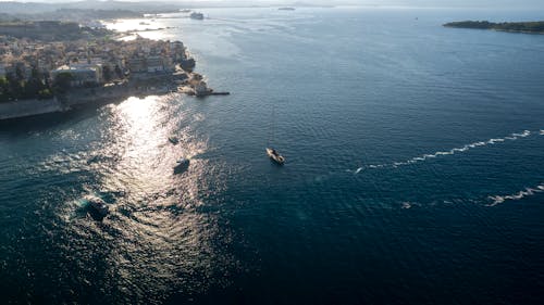 An Aerial Shot of a Yacht Approaching the Coast of Corfu