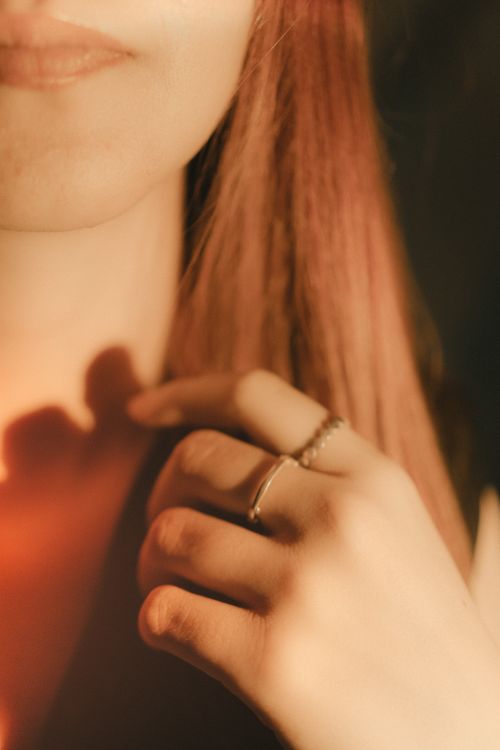Free A close-up of a woman's hand adorned with rings, highlighting elegance and style. Stock Photo