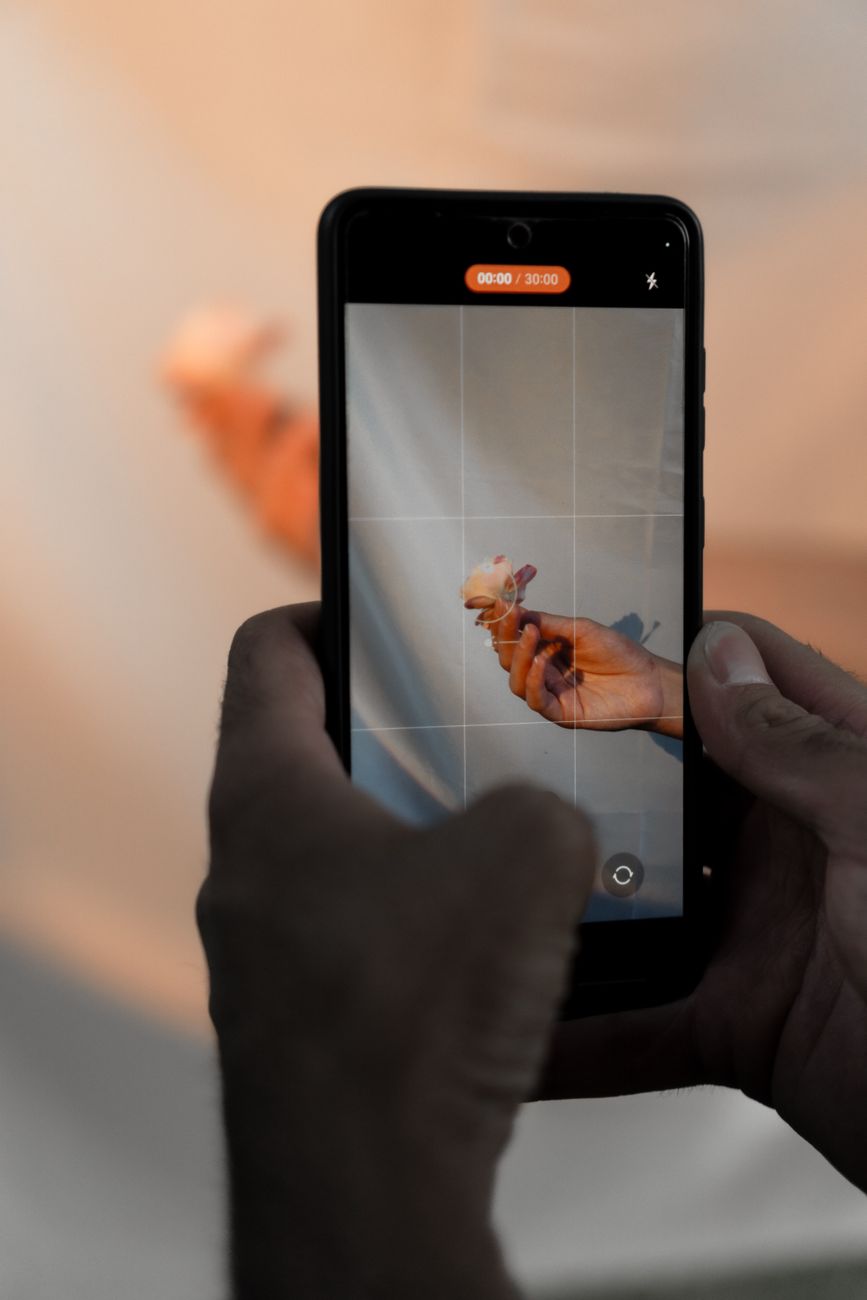 A smartphone held in a hand showing an app loading screen