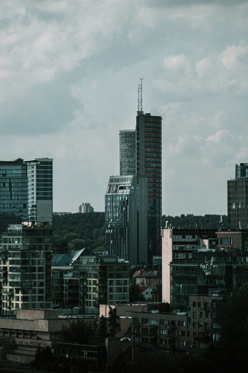 A striking view of Vilnius cityscape, showcasing modern skyscrapers against a cloudy sky.