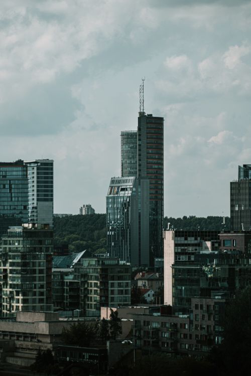 Free A striking view of Vilnius cityscape, showcasing modern skyscrapers against a cloudy sky. Stock Photo