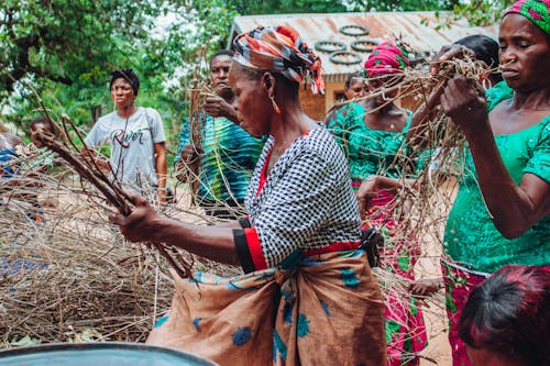 Women Holding Wood in Hands during Ritual