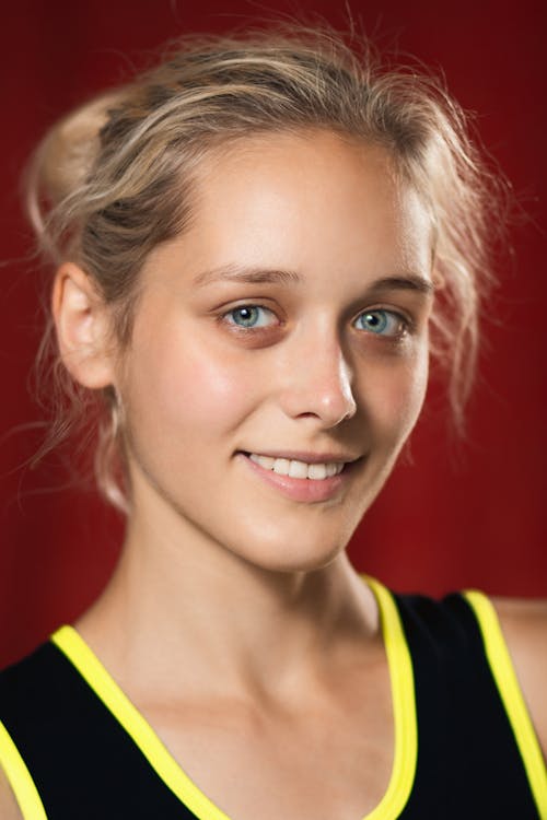 A young woman with blonde hair and blue eyes