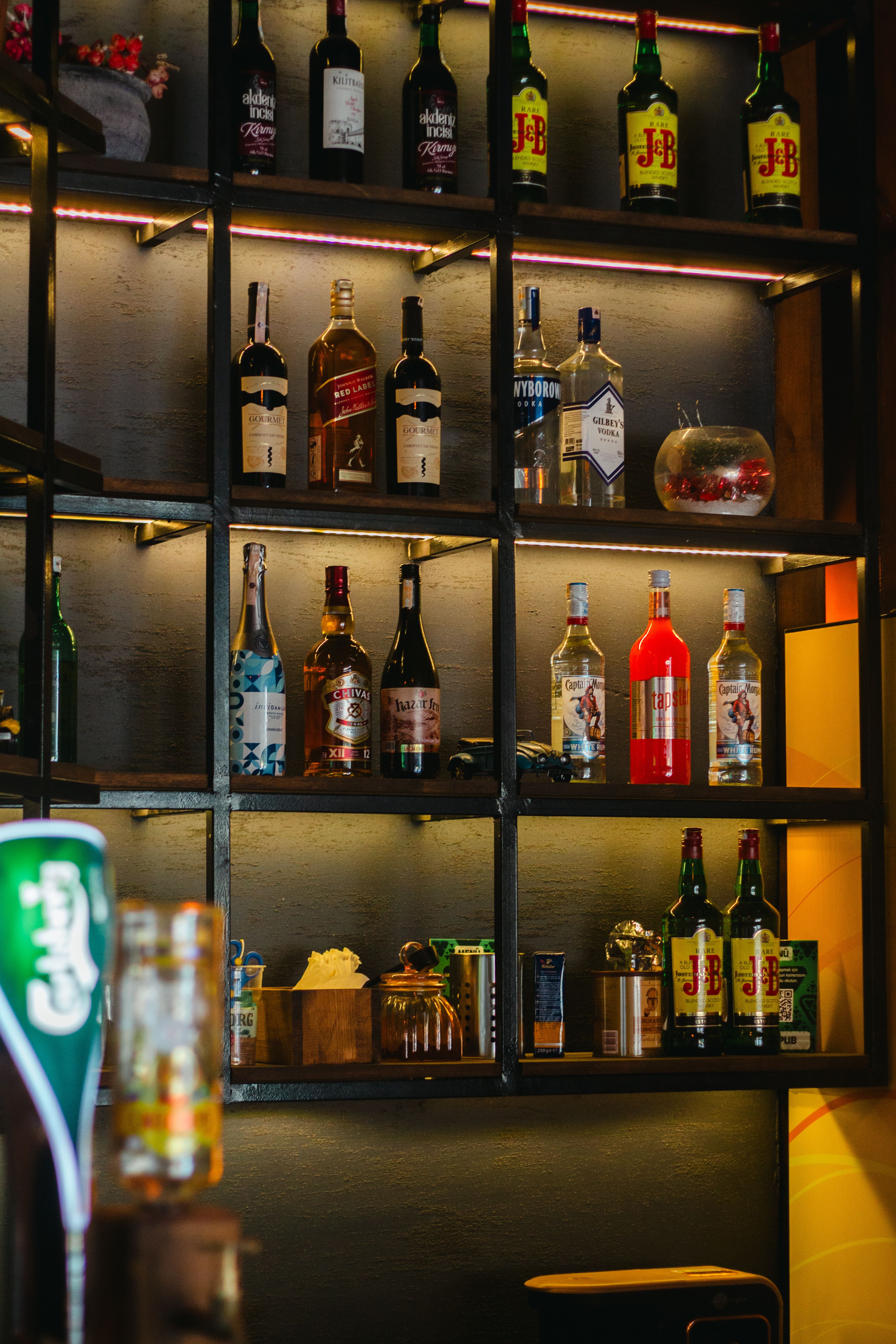 Bottles with Alcohol on Shelves in Bar · Free Stock Photo