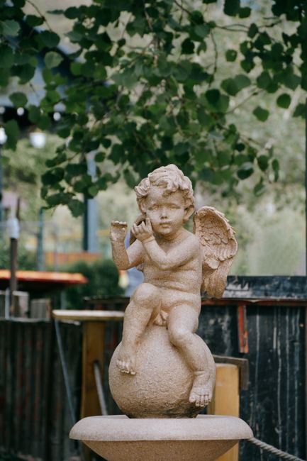 Stone cherub statue in a park in Talgar, Almaty Region, Kazakhstan.