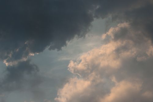 Free View of dramatic clouds with sunlight softly illuminating, creating a serene, contrasting cloudscape. Stock Photo