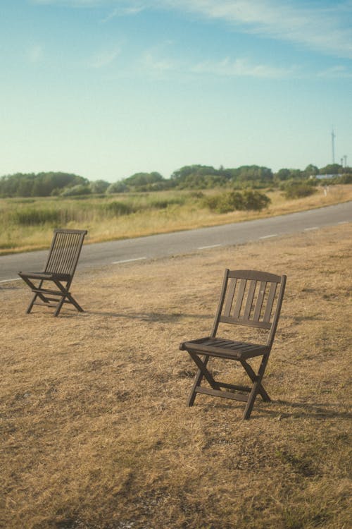 Wooden Chairs near Road in Countryside