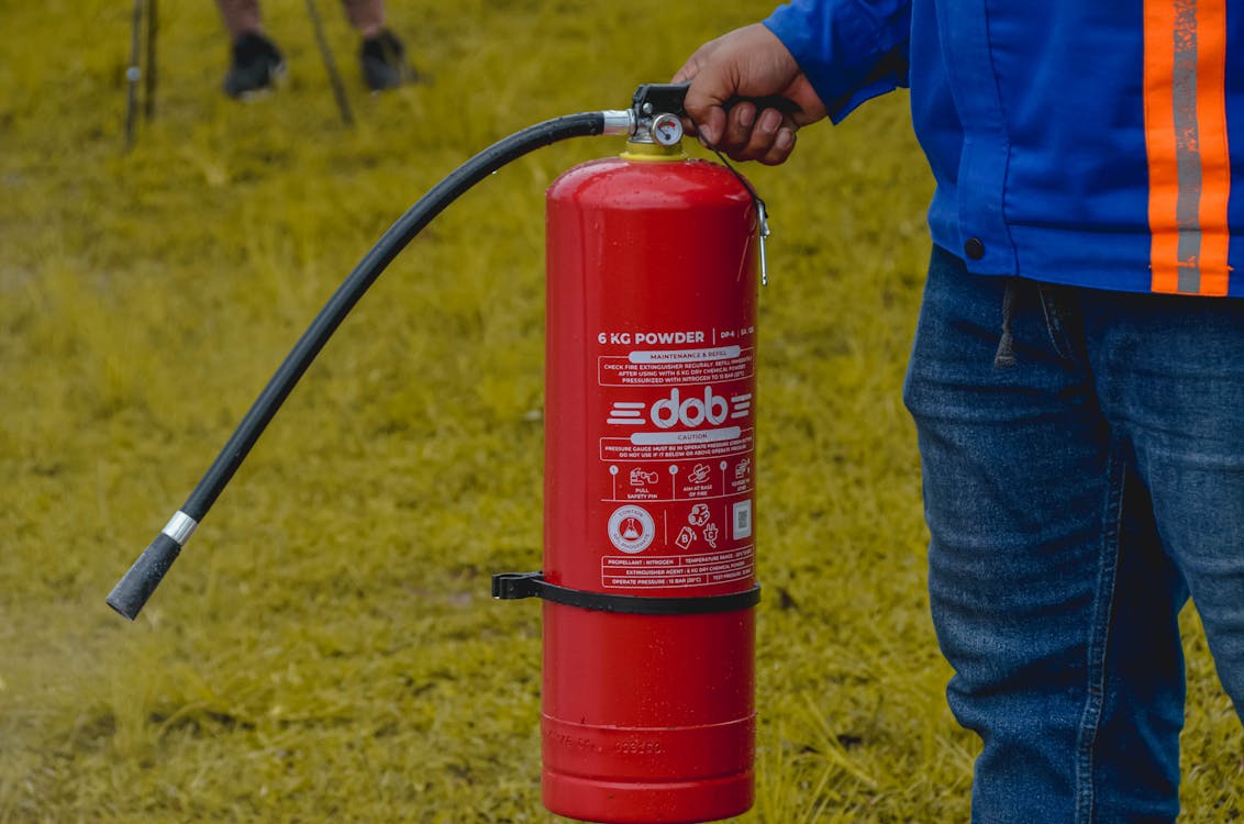 A person is taking a fire safety course after searching online for fire extinguisher training near me