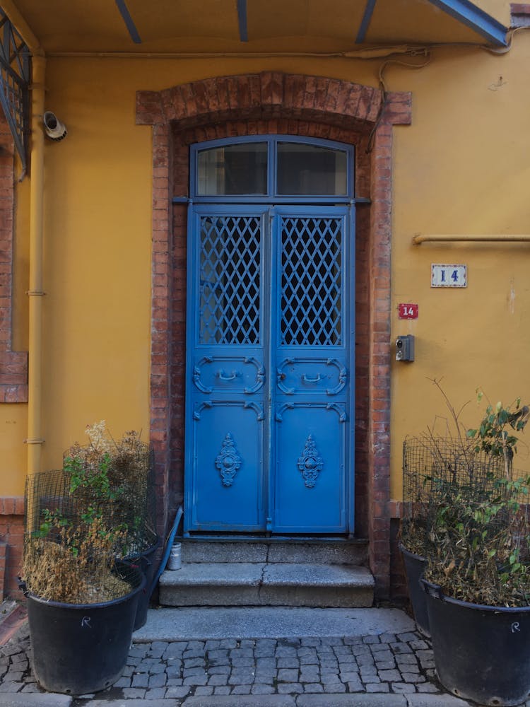 An Old House With Blue Door In A Town 