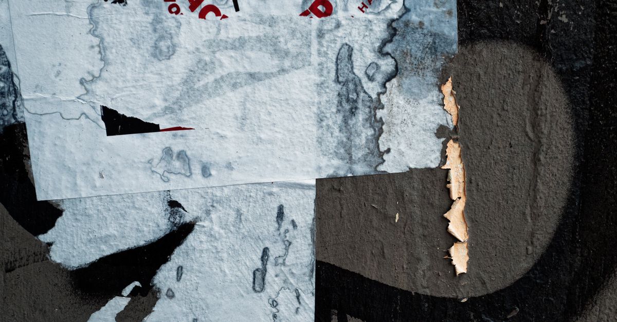 Remnants of Torn Posters on the Wall · Free Stock Photo