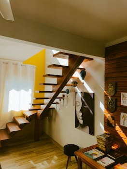 A contemporary wooden staircase in a sunny, stylish interior space.