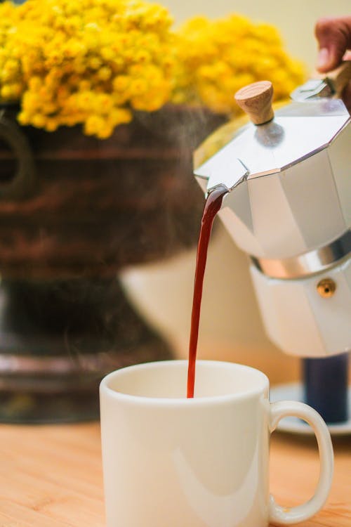 Free Pouring Coffee from Moka Pot Stock Photo