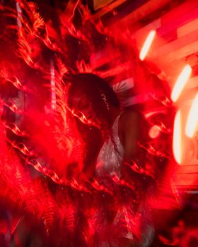 Dynamic abstract portrait of a woman with vibrant red lighting and artistic effects.