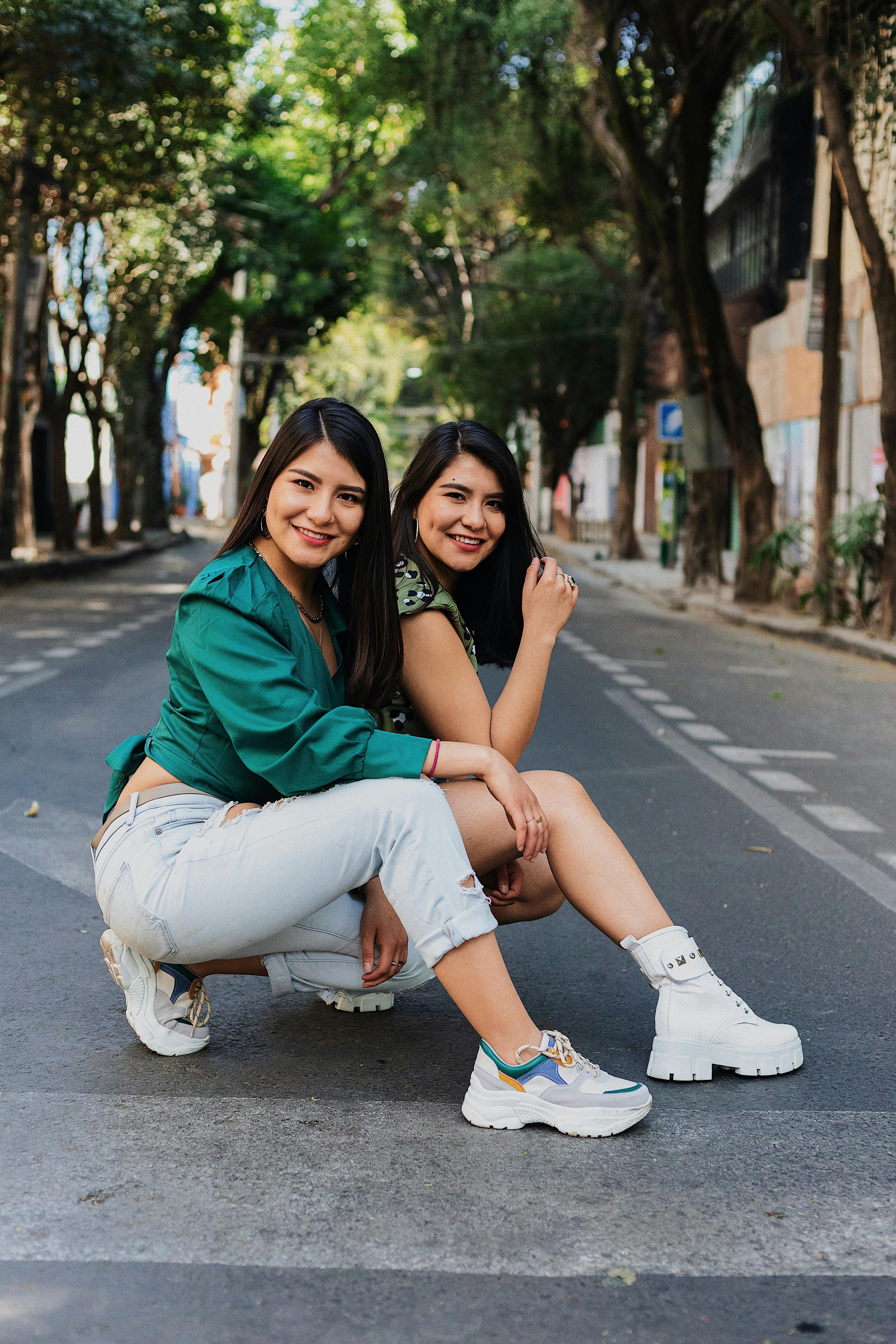 twin sisters posing on the street in city