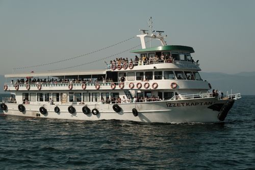 Free A crowded ferry named Izzet Kaptan sailing on a sunny day in Turkey, full of passengers enjoying the sea. Stock Photo