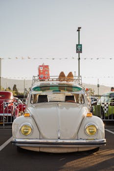 A classic white vintage Beetle car displayed outdoors at a fair in Reno, Nevada.