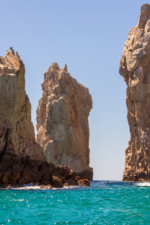 Rock Formations on the Shore with Turquoise Water 