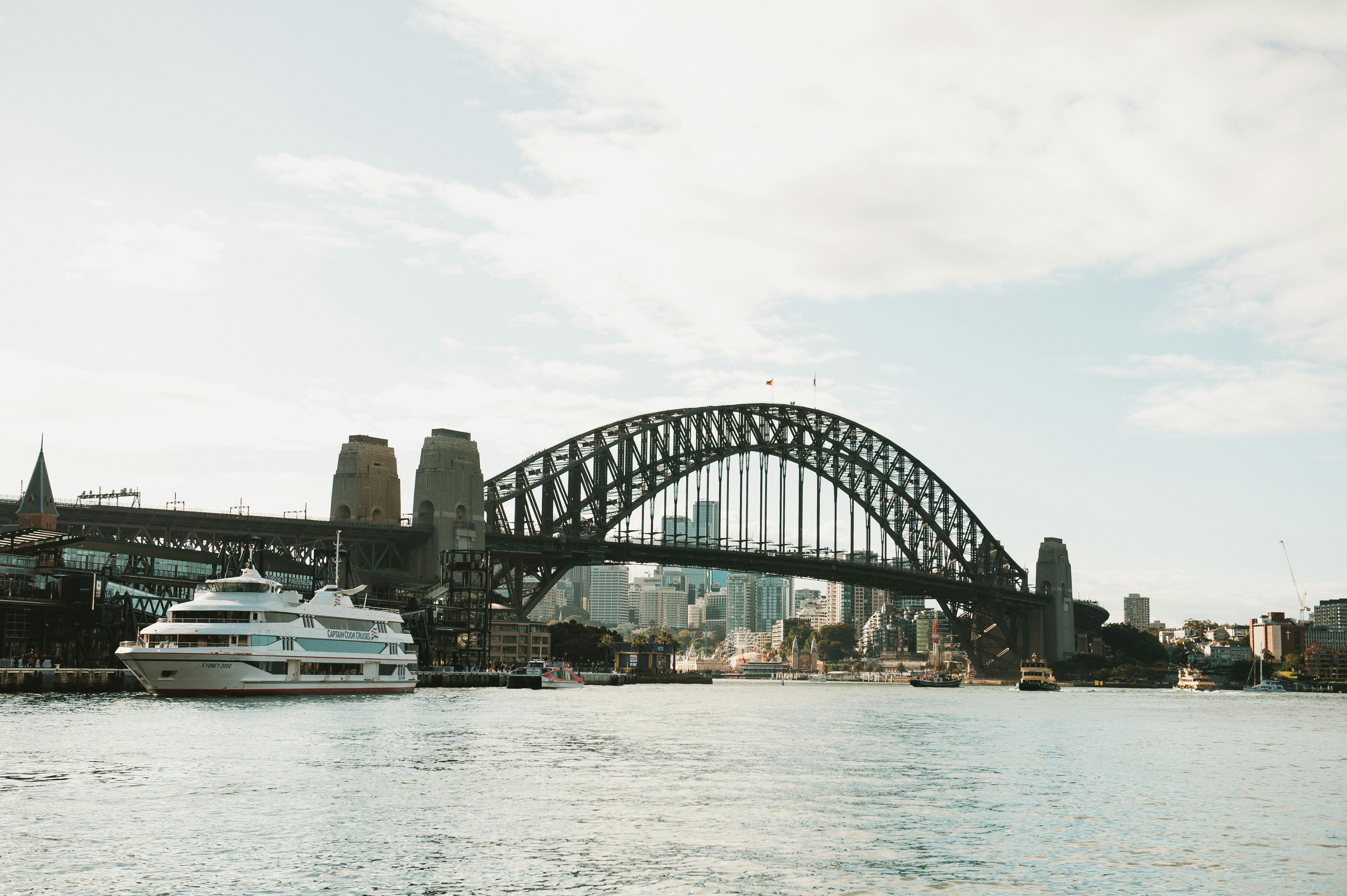 Free View of the Sydney Harbour Bridge with a cruise ship on a sunny day. Stock Photo