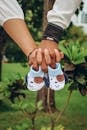 Couple Holding Child Shoes