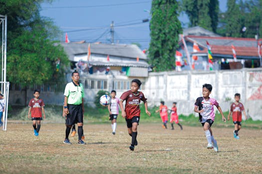 Children playing soccer during a bright day in Indonesia. Captured by Canon EOS 5D.