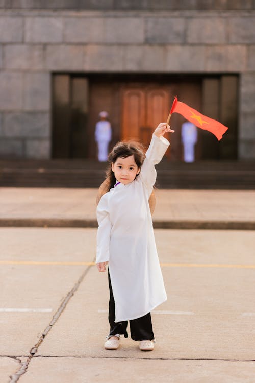 Little Girl Posing with a Flag of China in her Hand 