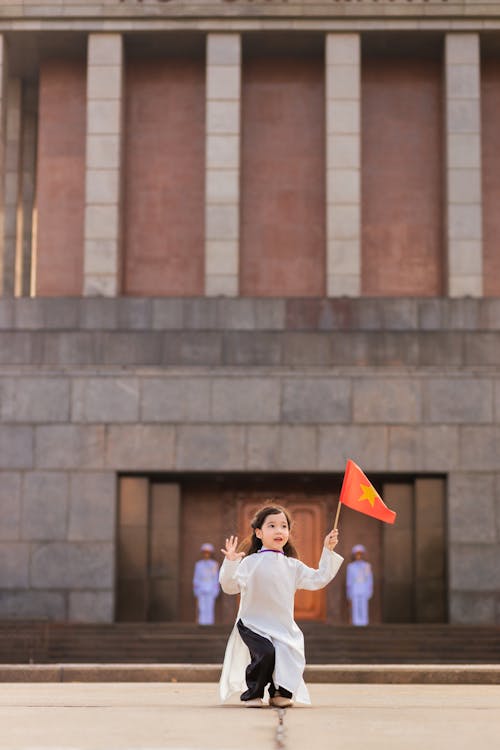 Girl Posing with a Flag of China in her Hand 