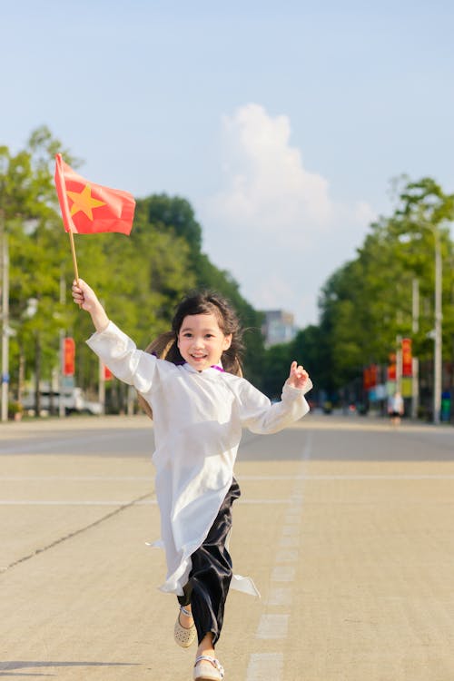 Girl Running with a Flag of China in her Hand 