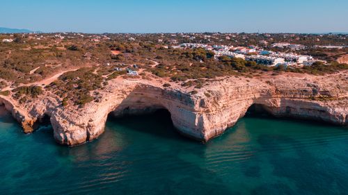 Free Stunning aerial view of Benagil Cave and coastal cliffs in Algarve, Portugal, with clear turquoise waters. Stock Photo
