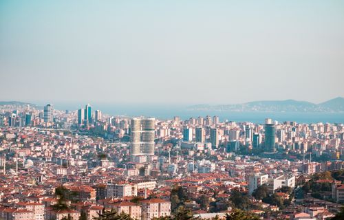Free Stunning aerial view of a vibrant cityscape featuring modern skyscrapers and vast urban sprawl under clear skies. Stock Photo