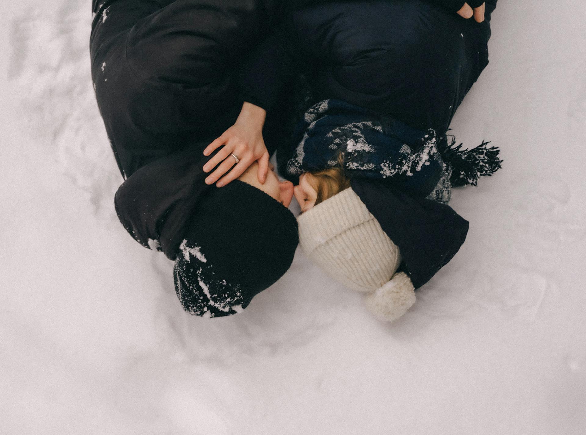 Young Couple Lying Face to Face in the Snow