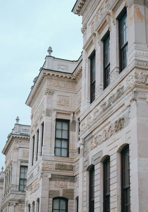 Free Detailed view of ornate baroque architecture with large windows on a historic palace facade. Stock Photo