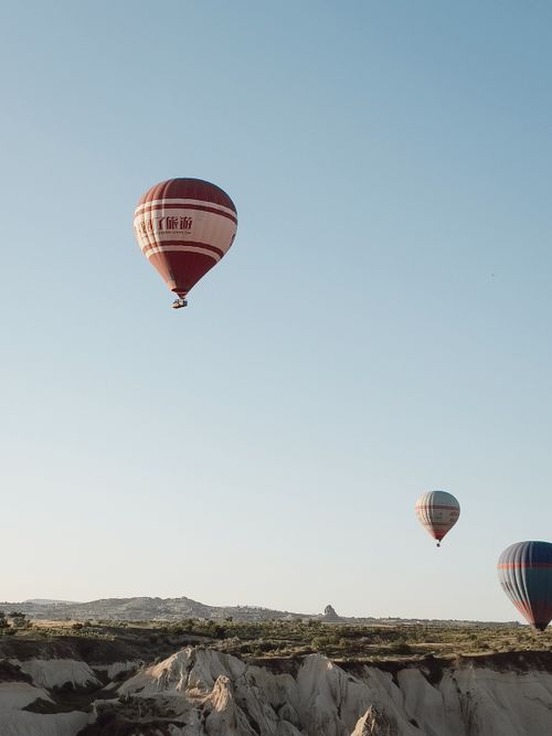 Free Hot air balloons soar over Cappadocia's unique landscape, capturing the magic of flight. Stock Photo