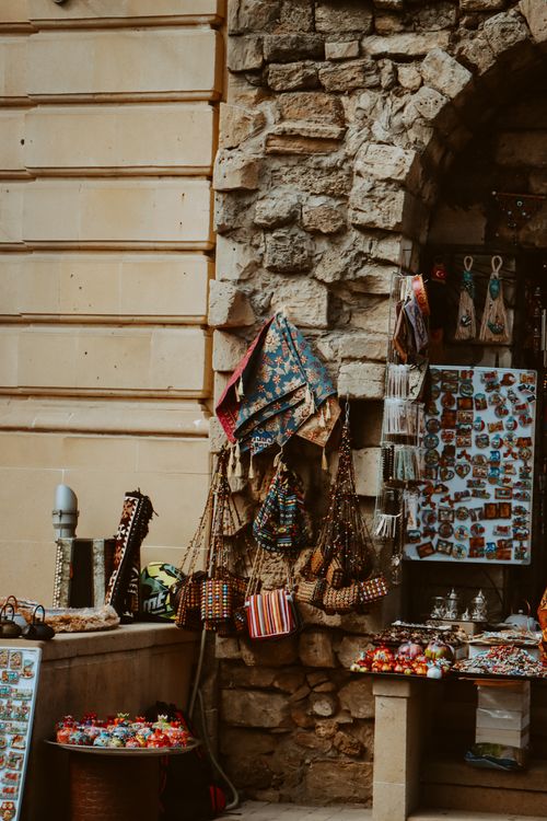Free Discover vibrant souvenirs and cultural items at a market stall in historic Baku, Azerbaijan. Stock Photo