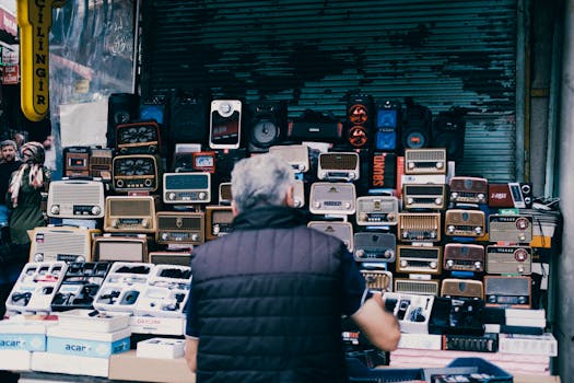 A bustling urban street market stall featuring a collection of vintage radios and electronics.