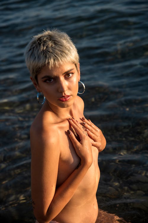 Shirtless Woman Covering Breast with Hands