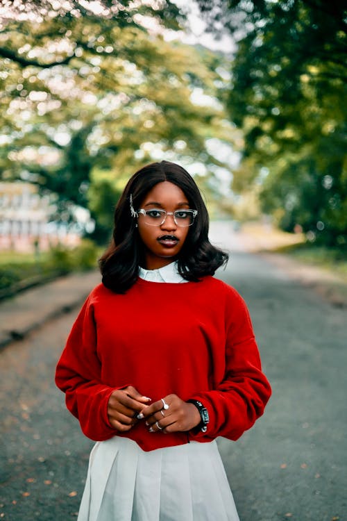 Young Fashionable Woman in a Red Sweater Standing Outside 