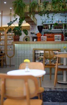 Charming café interior in Istanbul featuring plants and modern furniture.