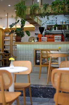 Cozy Istanbul café interior featuring lush greenery and wooden accents.