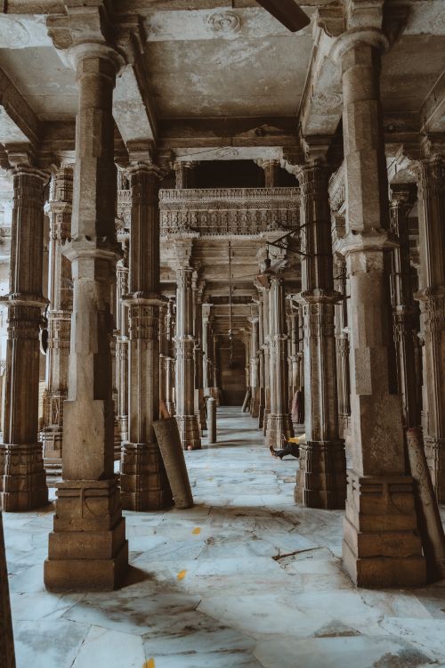 Free Vertical view of ornate pillars inside Jama Mosque, showcasing Indo-Islamic architecture. Stock Photo