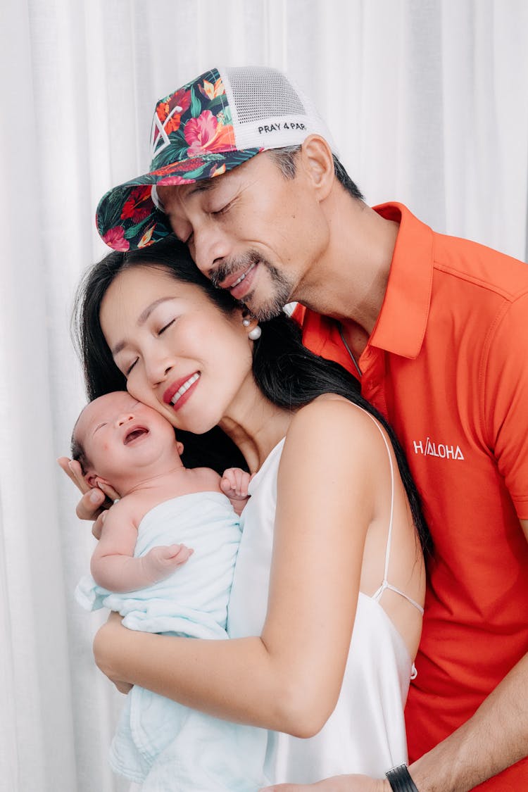 Smiling Couple With Baby