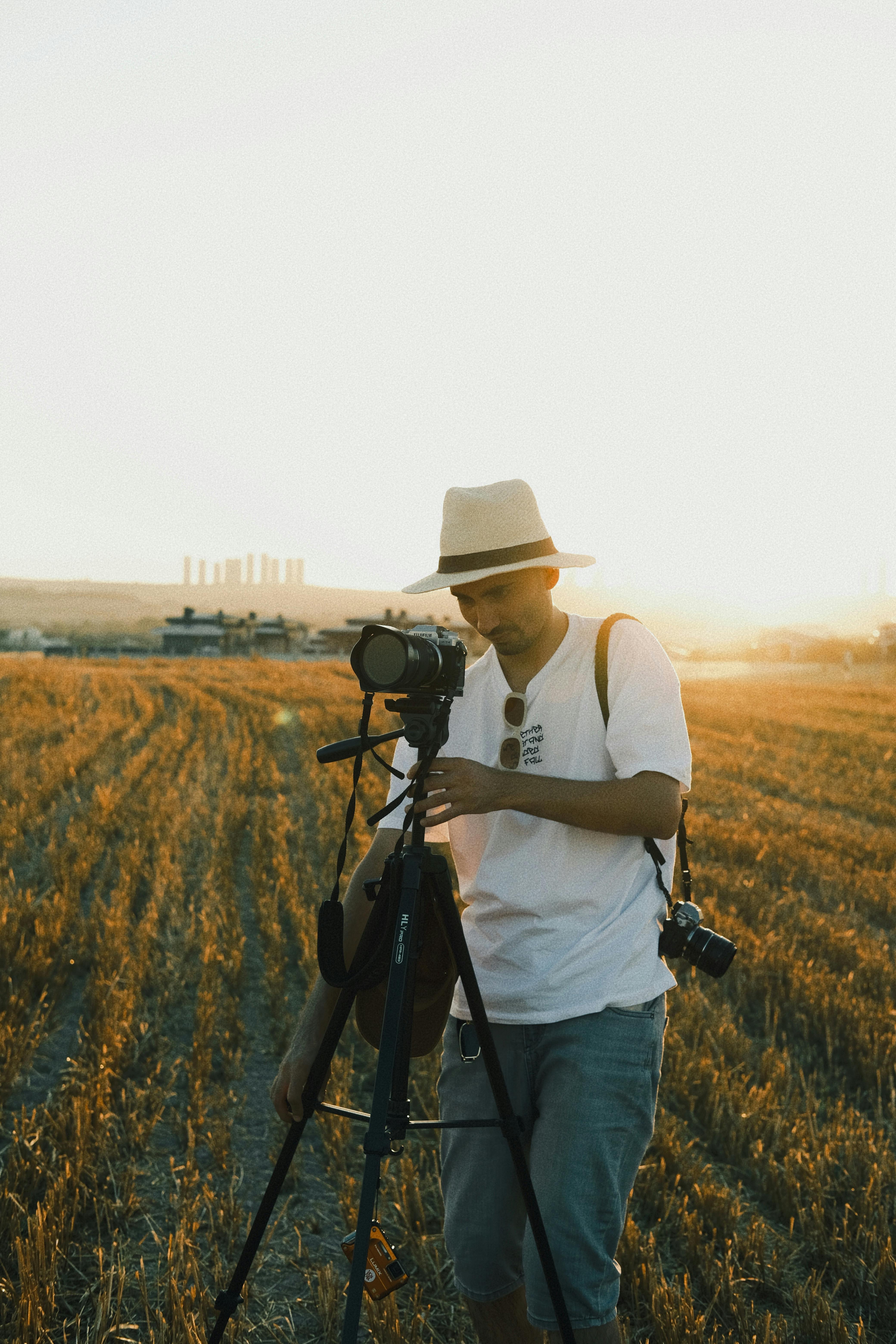 Photographer with camera and tripod composing a mountain landscape