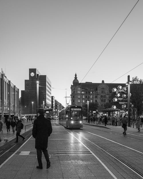 People and Tram on Street in Black and White