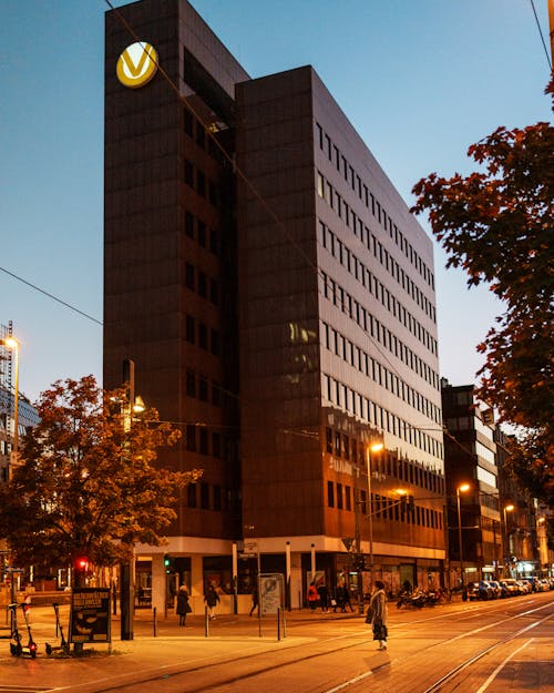 View of a Street and Modern Office Building in City in the Evening 