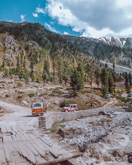 Cars on a Trail in Mountains 