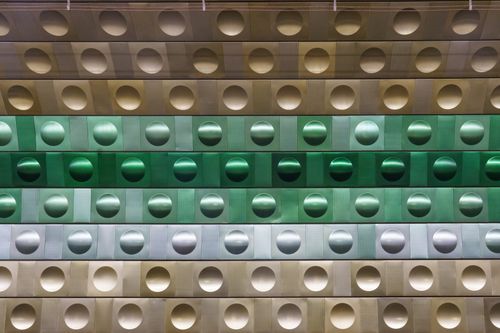Free Abstract view of a geometric metallic wall in a Prague metro station, featuring circles and green hues. Stock Photo