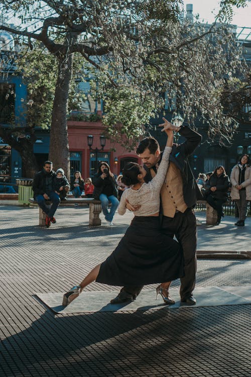 People Watching a Pair of Tango Dancers Performing on a Street