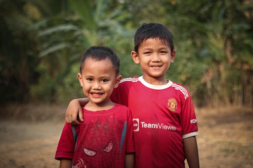 Happy Little Boys in Red Shirts