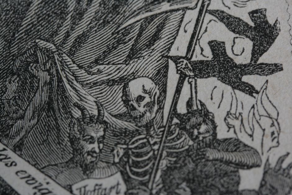 Detailed black and white artwork showing a skeleton with scythe and devil figure, symbolizing death.