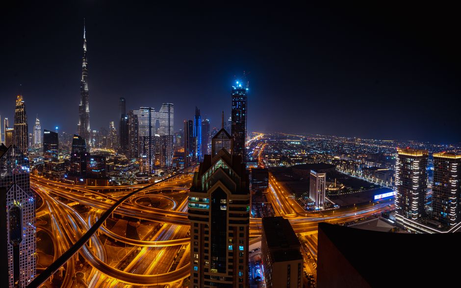 Spectacular Helicopter Ride in Dubai - Peal Heli Tour - 12 Min Flight Review Review 2026 - Stunning aerial view of Dubai cityscape featuring illuminated skyscrapers and highways at night.